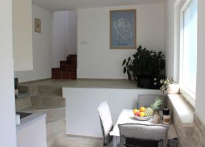 a dining room with a table with a bowl of fruit on it at Horizont view apartment in Pula