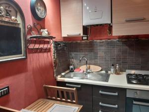 a small kitchen with a sink and a counter top at Casita Esperanza in Copparo