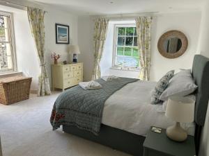 a bedroom with a bed and a window at Underwood House Garden Flat in Kilmarnock