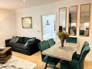 a living room with a table and a couch at Urban Heaven with free parking in Bracknell