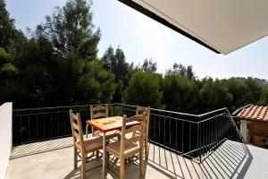 a table and two chairs sitting on a balcony at Spacious Villa near Porto - BBQ and Private Parking in Vila Nova de Gaia