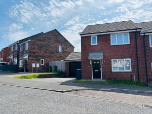 two brick houses on the side of a street at Beautiful 3 bed holiday home in Washington, UK in Washington
