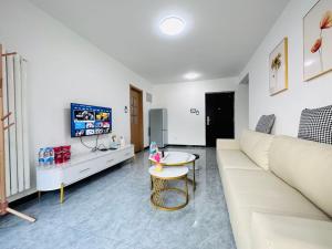 a living room with a white couch and a table at Little Room in Ruakura Junction