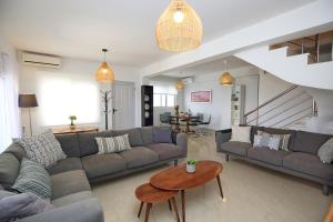 a living room with a couch and a table at Salt and Sun in Nikiana