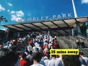 a large crowd of people walking into a stadium at Bright 4BR 2BA Gem in Wembley Harrow - Sleeps 8 in Kenton