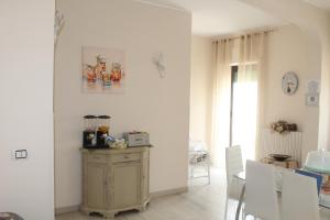 a living room with a wooden cabinet and a window at Donna Melina in Mileto