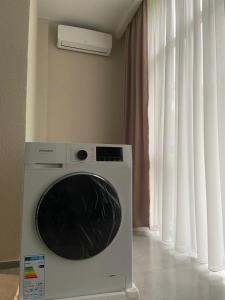 a washing machine in a room with a window at Leveta Botanical Garden in Batumi