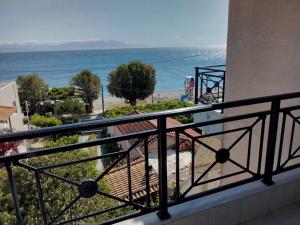 a balcony with a view of the ocean at Anastasia in Paralía Akrátas +8 photos