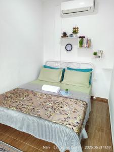 a small bedroom with a bed in a room at Teratak Yoi in Pantai Cenang