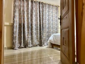 a bedroom with a shower curtain and a bed at Veranda Vista in Trofwi