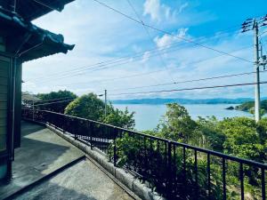 a view of the water from a house at ぽつんとオーシャンビューでバーベキューも出来る1日1組貸切宿カゴヤブハウス in Otsuki