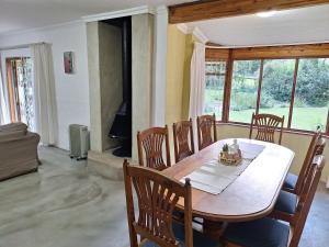 a dining room with a table and chairs in a room at L Chiam Self-Catering Cottage in Winterton