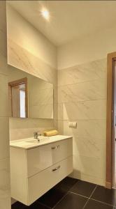 a bathroom with a sink and a mirror at Adan appartement in Aourir