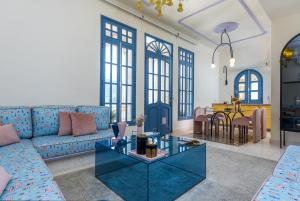 a living room with a blue couch and a table at Arnaoon Village in Batroûn