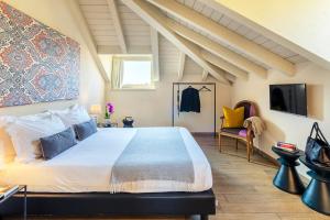 a bedroom with a large bed and a tv at Residenza Dell' Opera in Turin