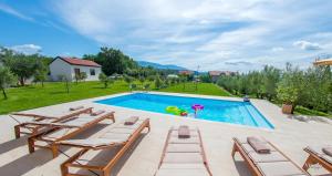 a swimming pool with lounge chairs and a pool at Holiday Home The Olive Escape in Stolac