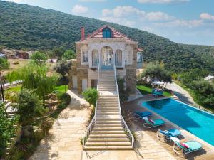 an aerial view of a house with a swimming pool at Arnaoon Village in Batroûn