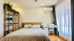 una camera da letto con un letto con un cuscino rosa di 20 minutes to Mel CBD 2 BRs AirCon unit guest house a Laverton