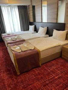 Postel nebo postele na pokoji v ubytování Nida Hotel Cıty Center