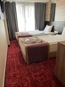Postel nebo postele na pokoji v ubytování Nida Hotel Cıty Center