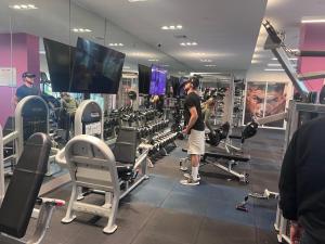 un homme debout dans une salle de sport avec des poids dans l'établissement Master Bedroom In CALLE OCHO, à Miami