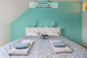 a bedroom with a large bed with two pillows at Apartma Lea in Slovenj Gradec