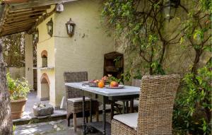 a table with fruit on it in a patio at 2 Bedroom Stunning Apartment In Seravezza in Seravezza