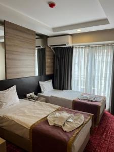 Postel nebo postele na pokoji v ubytování Nida Hotel Cıty Center