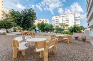 a patio with tables and chairs and buildings at Torreblanca E&S in Torrevieja