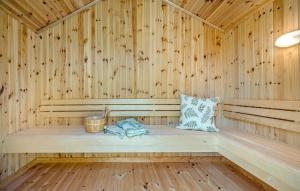a sauna with a bench in a wooden room at Stunning Home In Sjællands Odde in Yderby +9 photos