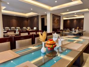 a dining room with a long table and chairs at Hotel Nalanda Ladakh in Leh