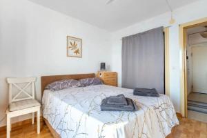 a bedroom with a bed with two towels on it at Torreblanca E&S in Torrevieja