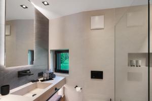 a bathroom with a sink and a shower at Chalet Ski in Selva di Val Gardena +27 photos