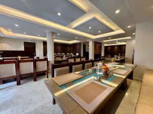 a restaurant with a dining room with tables and chairs at Hotel Nalanda Ladakh in Leh