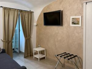 a living room with a tv on the wall at Chiaia Suites in Naples