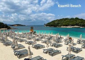 a group of chairs and chairs on a beach at Mihasi Apartments in Ksamil