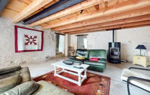 a living room with a couch and a coffee table at Lovely Home In Les Leves Et Thoumeyra in Les Lèves-et-Thoumeyragues
