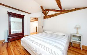 a white bedroom with a bed and a window at Lovely Home In Les Leves Et Thoumeyra in Les Lèves-et-Thoumeyragues
