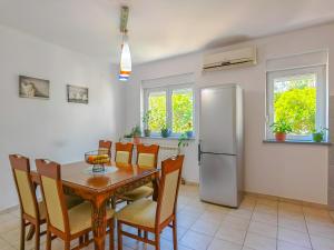 a kitchen with a dining room table and a refrigerator at The rising sun-Stylish Sea View Apartment in Budva