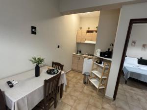 a room with a table and a kitchen and a bed at Nicolas Beach in Palaiochora