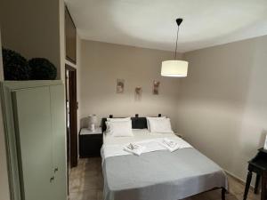 a bedroom with a bed with two books on it at Nicolas Beach in Palaiochora