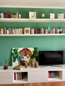 a flat screen tv sitting on top of a white shelf at Casa Mia Sirolo in Sirolo +30 photos