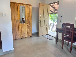 a room with a door and a desk and a window at Heritage Farm Kerala in Idukki