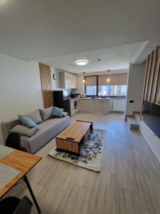 a living room with a couch and a coffee table at Sunny Family Vila Constanta in Constanţa