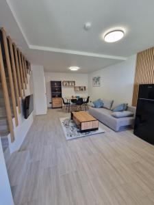 a living room with a couch and a table at Sunny Family Vila Constanta in Constanţa