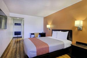 a hotel room with a bed and a desk at Motel 6 Sullivan MO in Sullivan