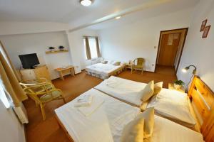 a bedroom with two beds and a living room at Resort Ohrada in Vísky +24 photos