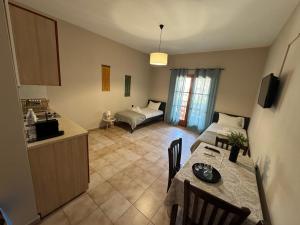 a kitchen and living room with a table and a couch at Nicolas Beach in Palaiochora