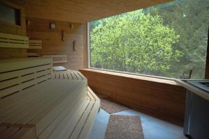 a room with a large window in a wooden room at Schwarzwald Wellnesshotel SAIGERHÖH I Spa Golf & Wandern über dem Titisee in Lenzkirch