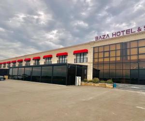 a large building with a sign on top of it at Baza Hotel Spa in Beylǝqan